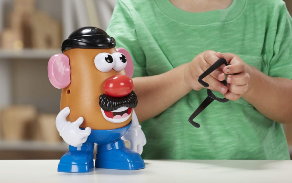 boy playing with Mr. Potato Head toy