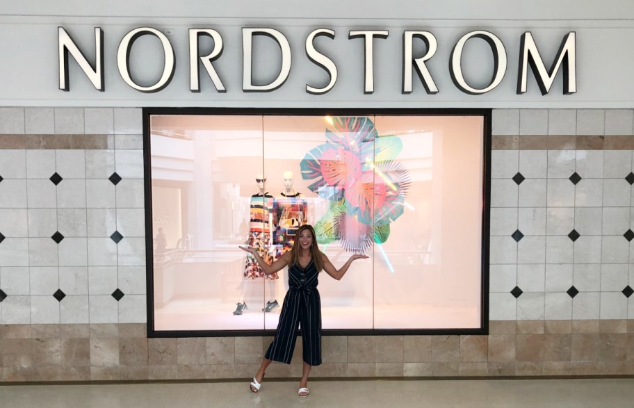 Woman standing outside a Nordstrom Storefront in anticipation of the Nordstrom Anniversary Sale