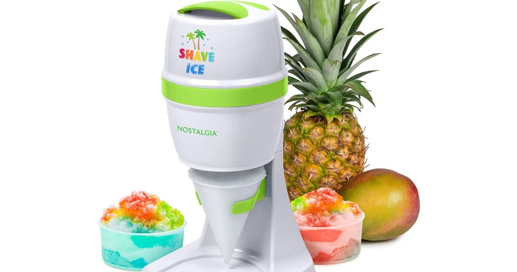 Nostalgia Electric Snow Cone Maker next to fruit and shaved rainbow ice