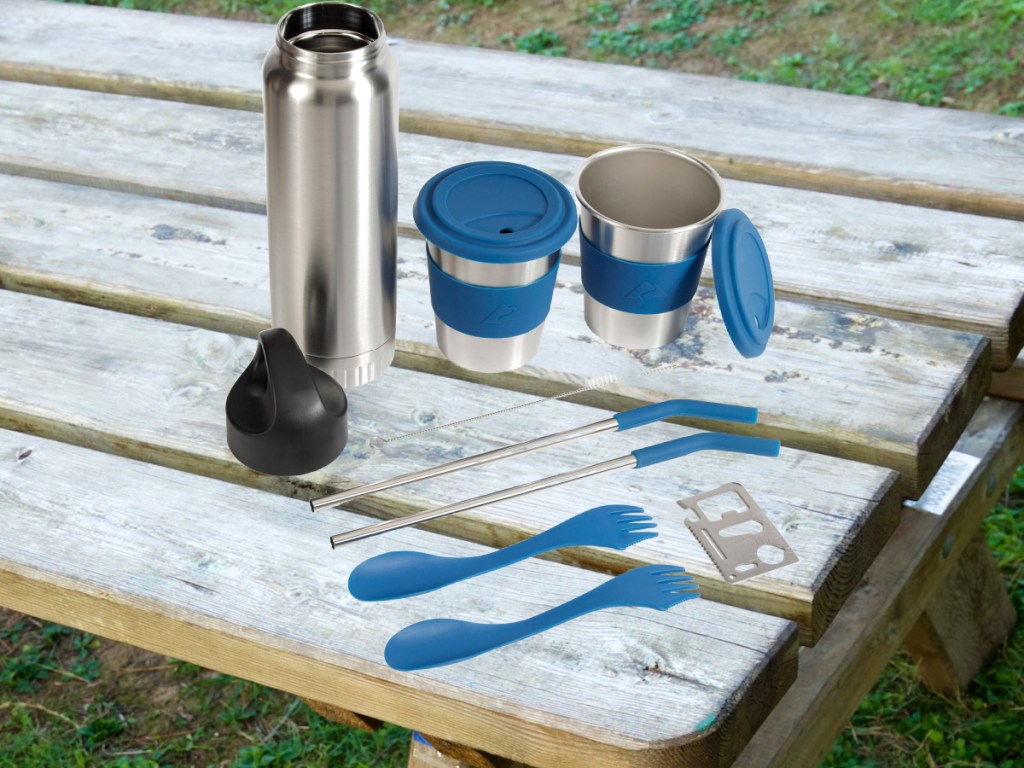 cutlery and drinkware set on outdoor picnic table