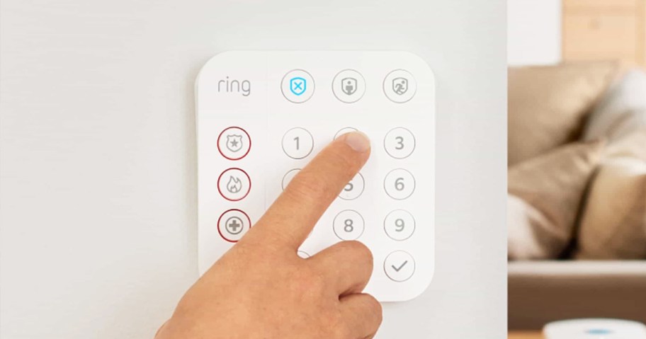 hand pressing number pad on a ring alarm