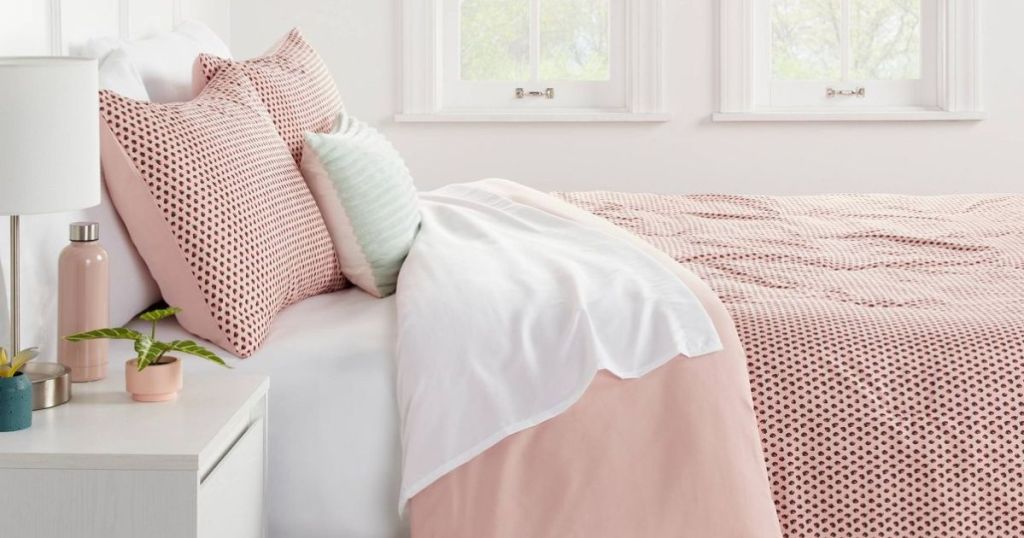 pink bedding set on a bed