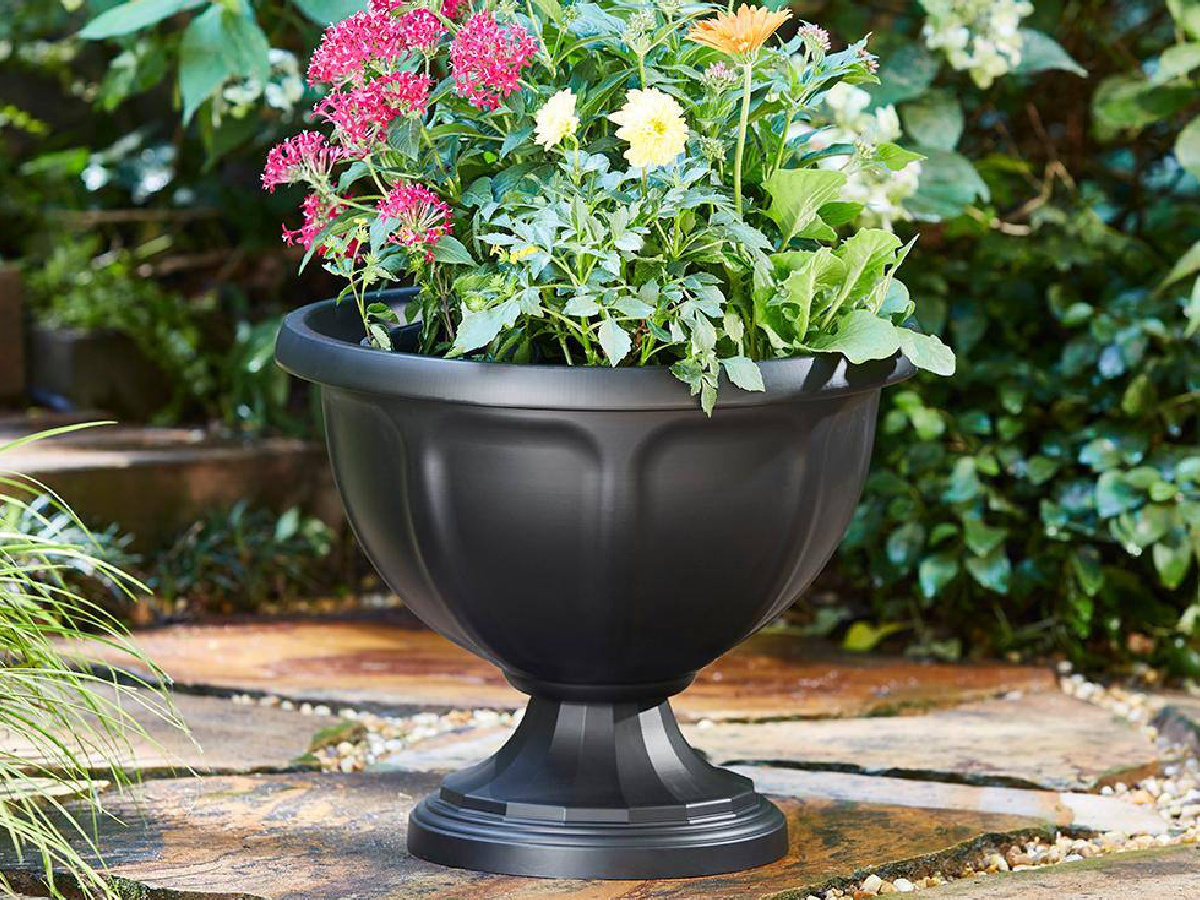 Black High-Density Resin Urn Planter with flowers in it 