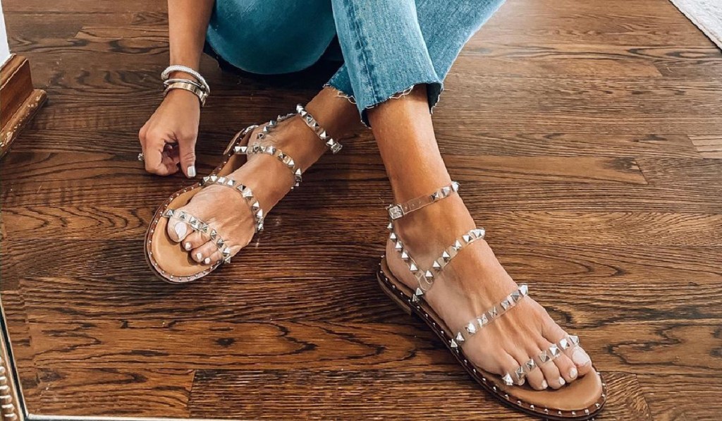 woman wearing jeans and studded sandals