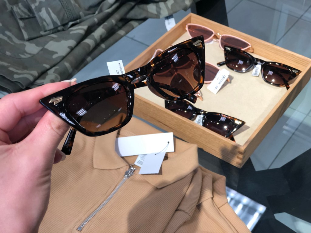hand holding a pair of sunglasses found at Nordstrom