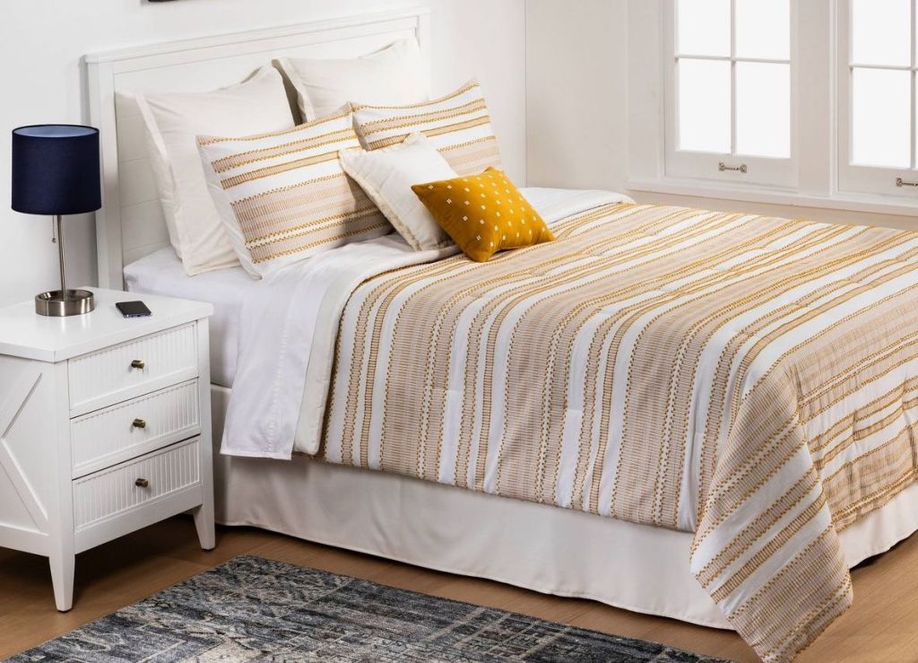 striped comforter on a bed