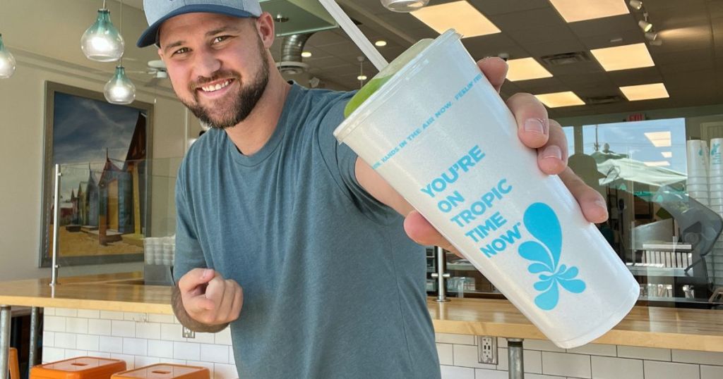 man holding a Tropical Smoothie Cafe smoothie