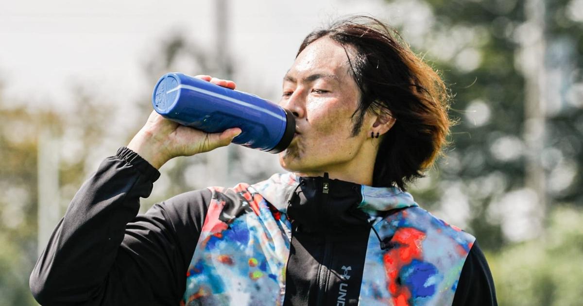 boy drinking out of blue under armour cup