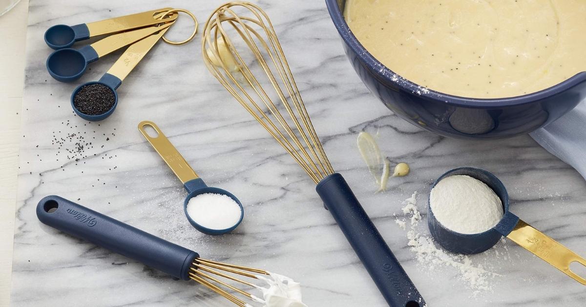 navy blue and gold wilton measuring cups, spoons, and whisks