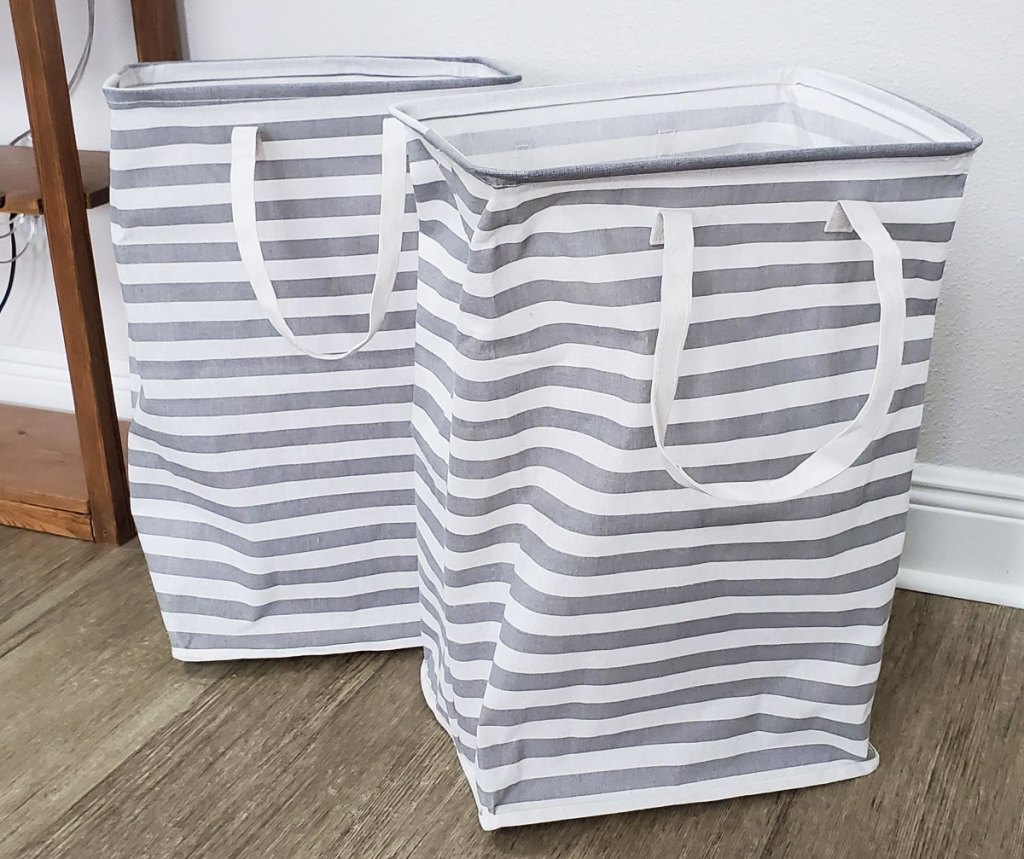 two white and grey striped laundry hampers