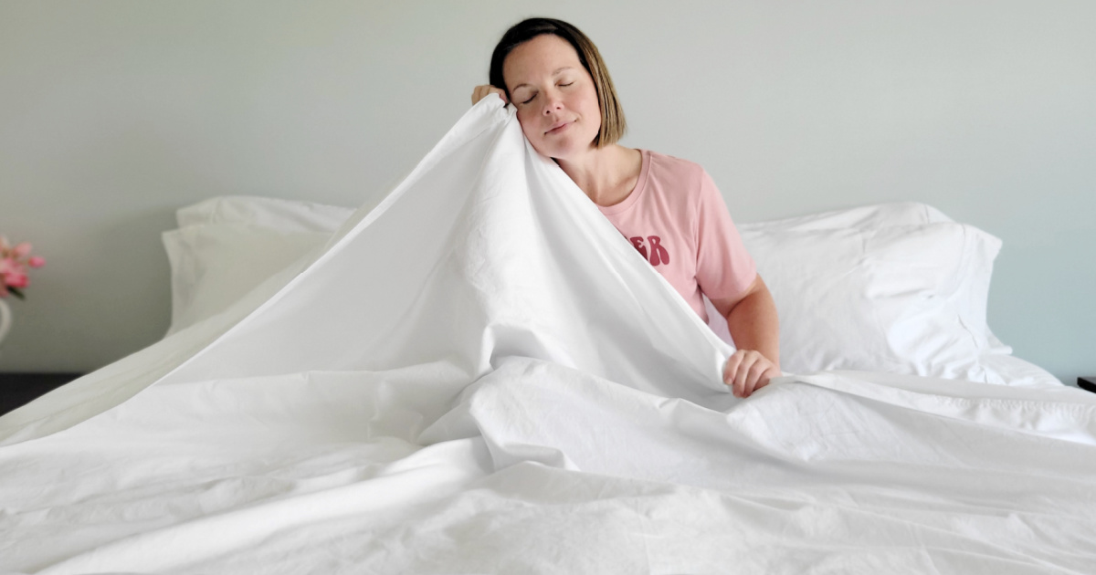 woman sitting in white sheets