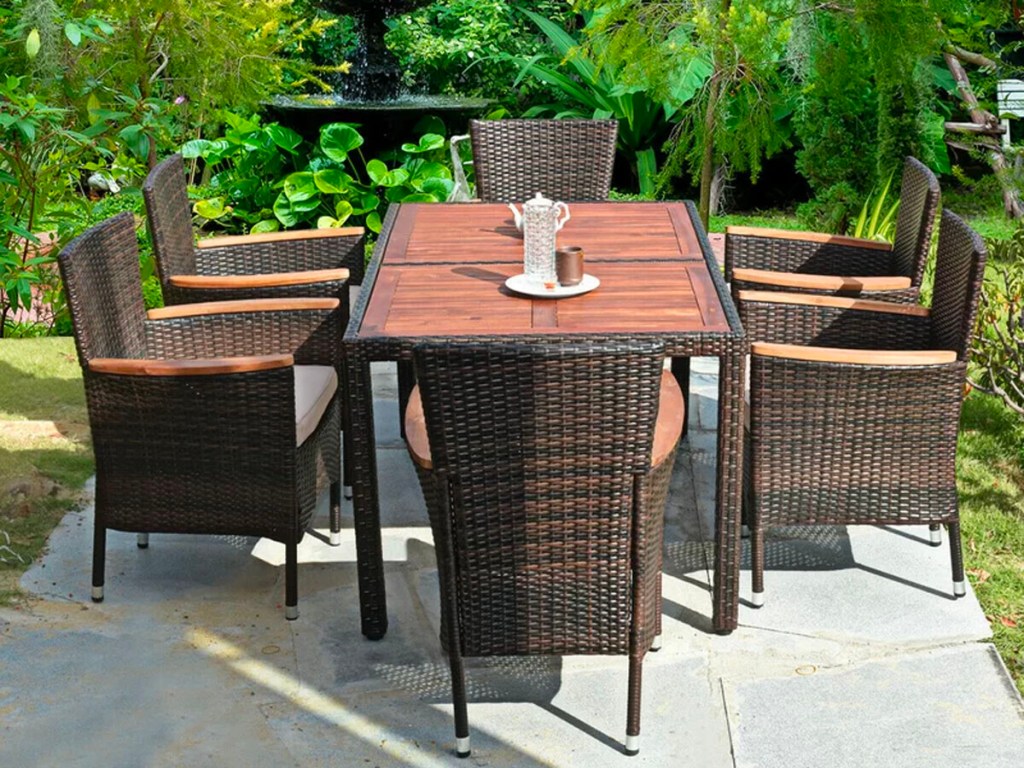 brown wicker table with 5 chairs on patio