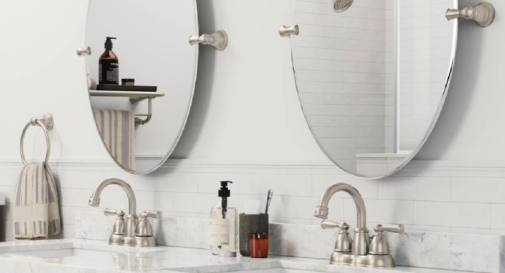 bathroom with two mirrors and faucets being showcased