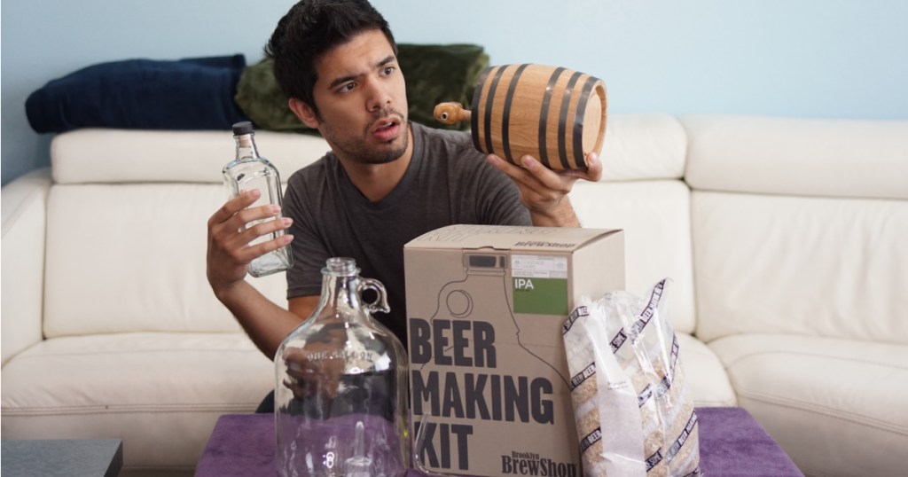 man holding beer making kit