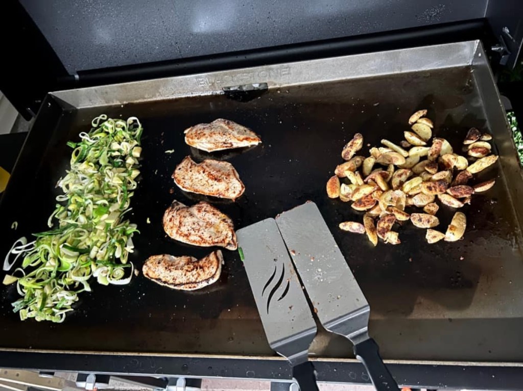 meat and vegetables on griddle