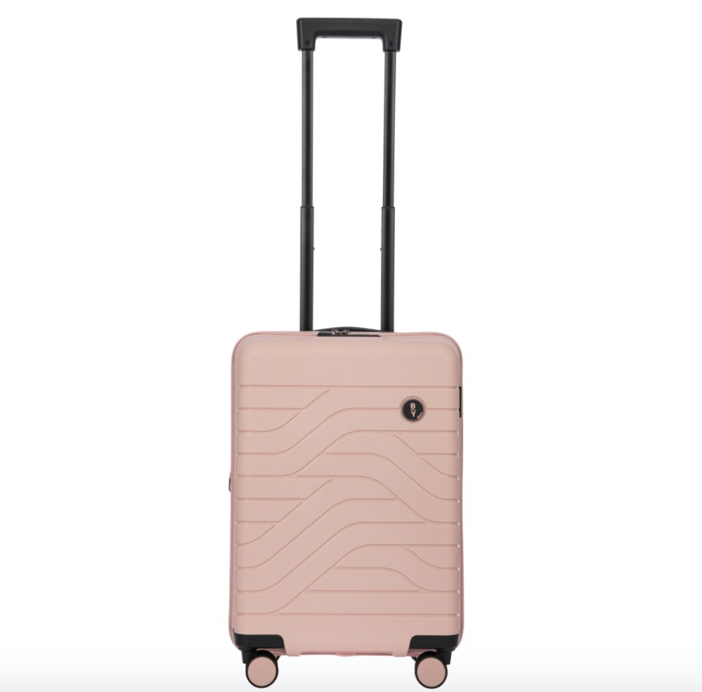 white stock photo of pink hardside luggage