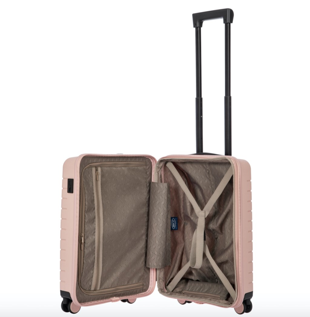 white stock photo of opened pink hardside luggage