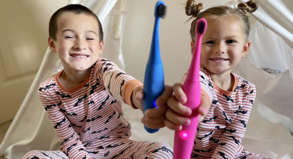 kids holding toothbrushes