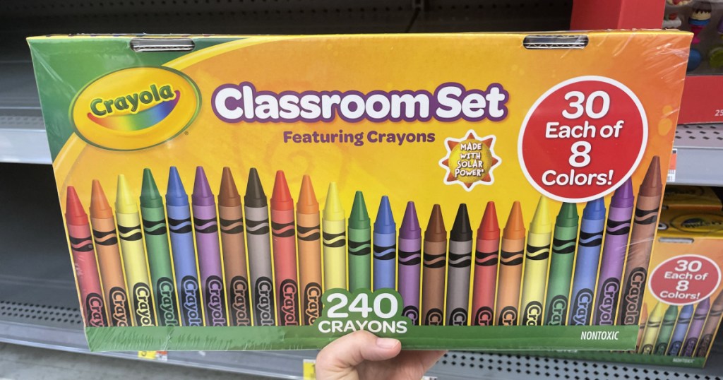 hand holding a crayola classroom set box of crayons in a store