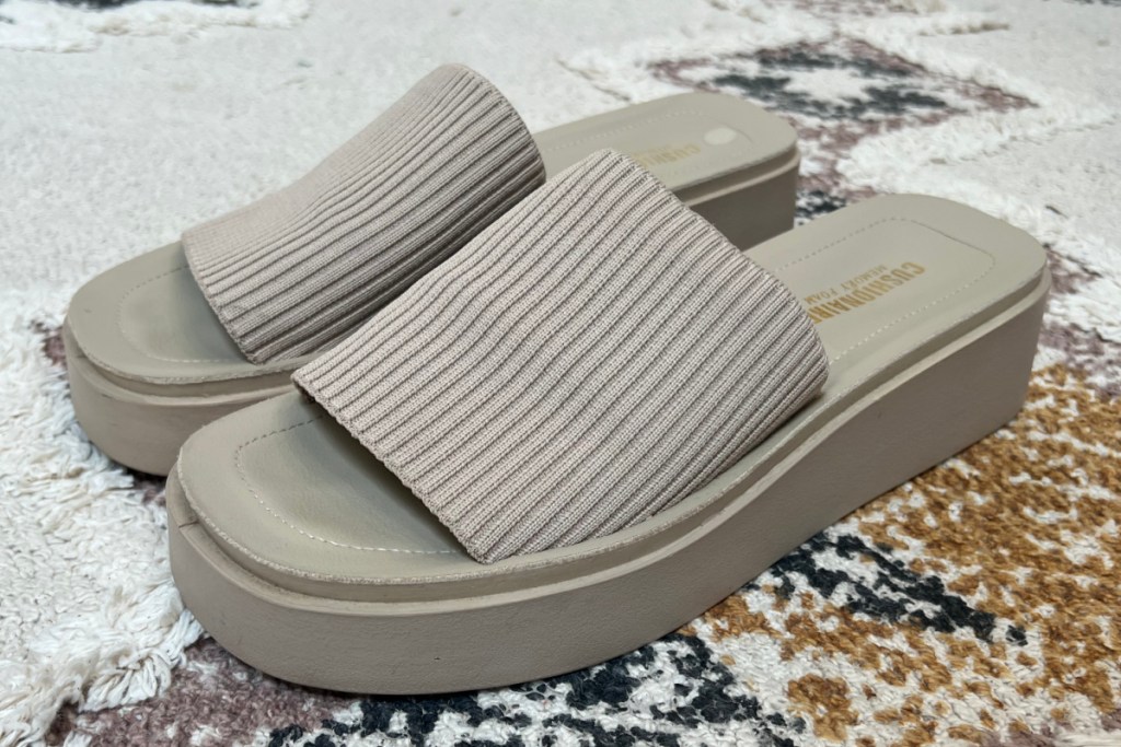 tan slide sandals with knit band on carpet