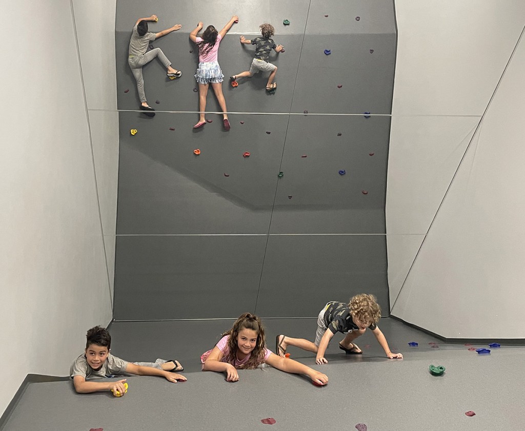 kids climbing on rock wall