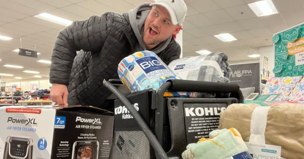 man with kohls shopping cart filled with stuff