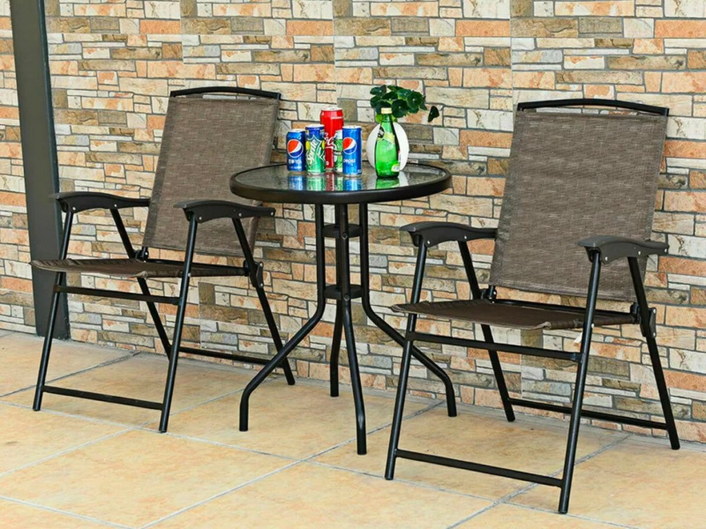 two brown folding chairs and table with snacks on table