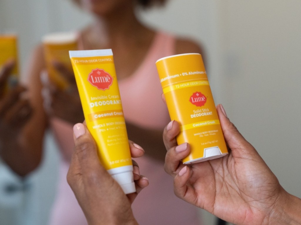 holding Lume deodorant and body lotion