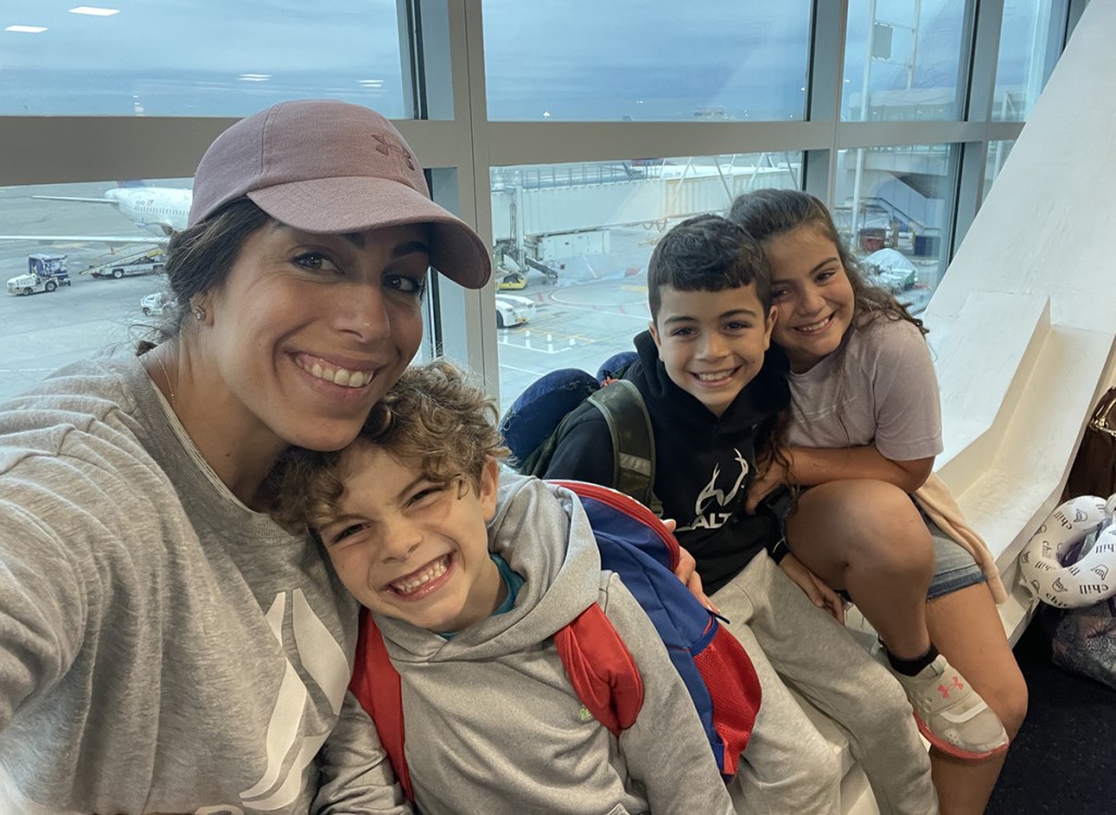 woman and kids at airport traveling