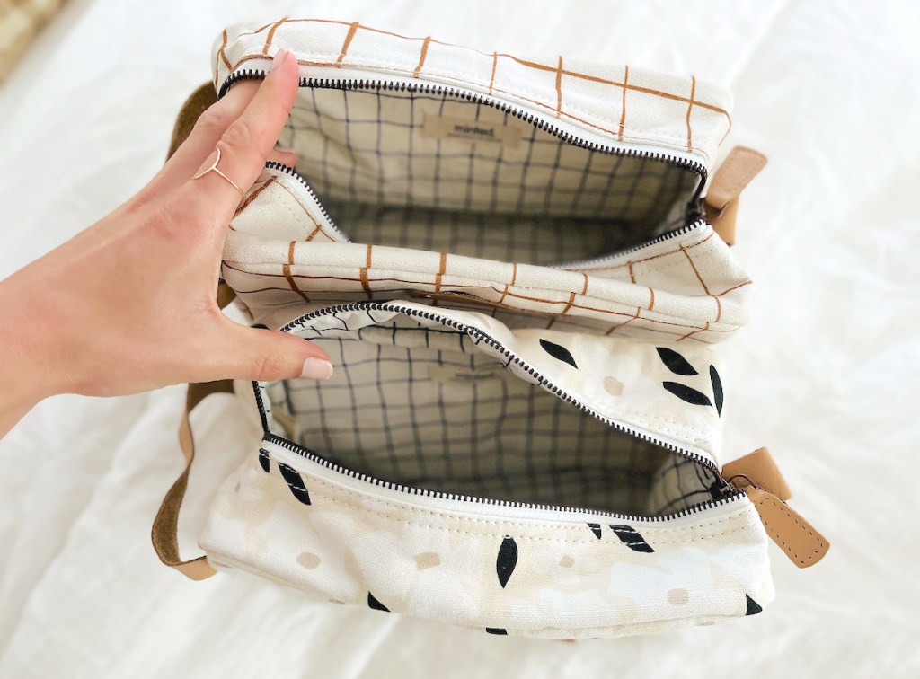 hand holding open minted dopp kit toiletry bags