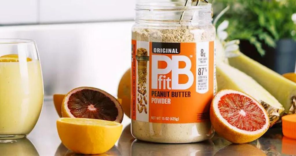pbfit jar on a kitchen counter with blood oranges and and a couple of smoothies15oz