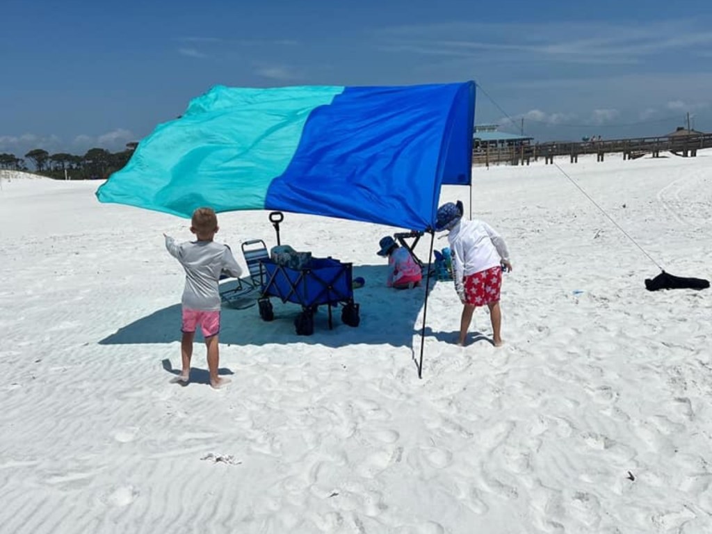 two-tone blue sun shade on white sand beach