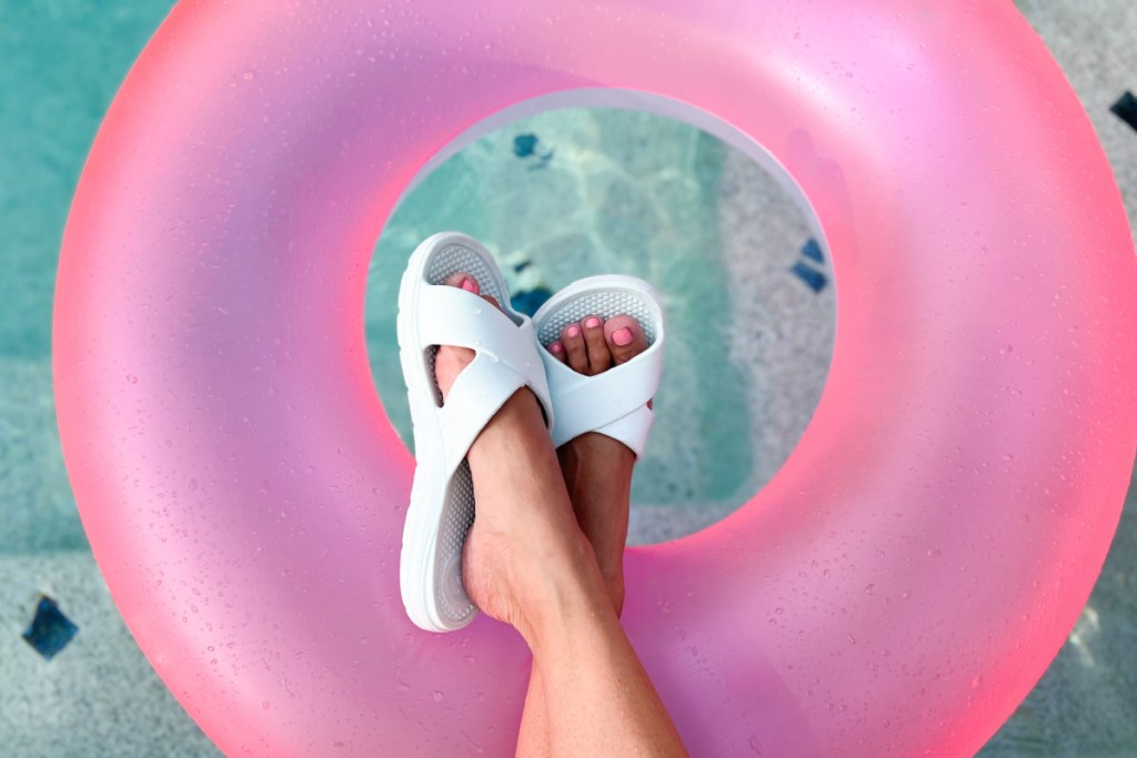 white sandals on pink floatie