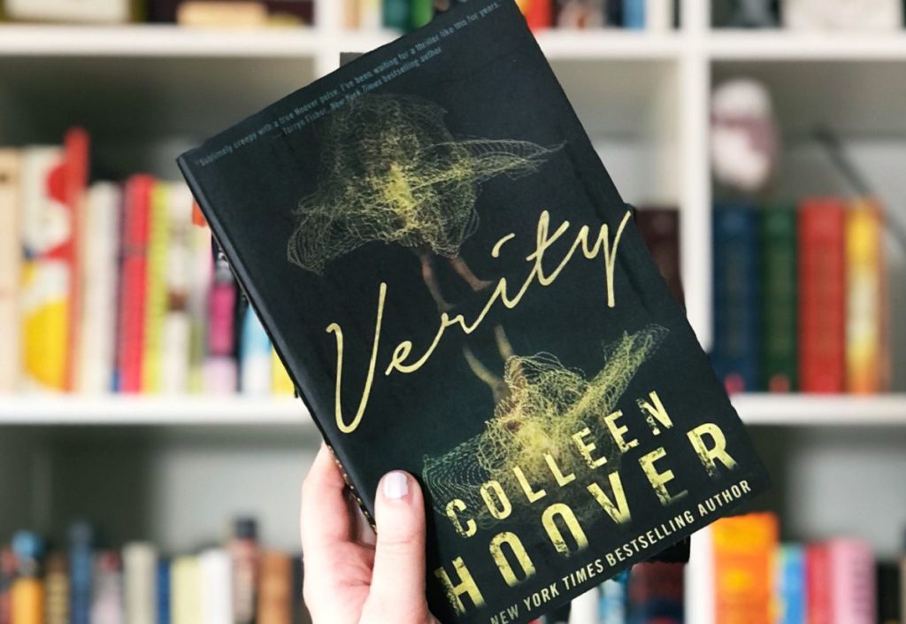 Hand holding a Verity hardcover book