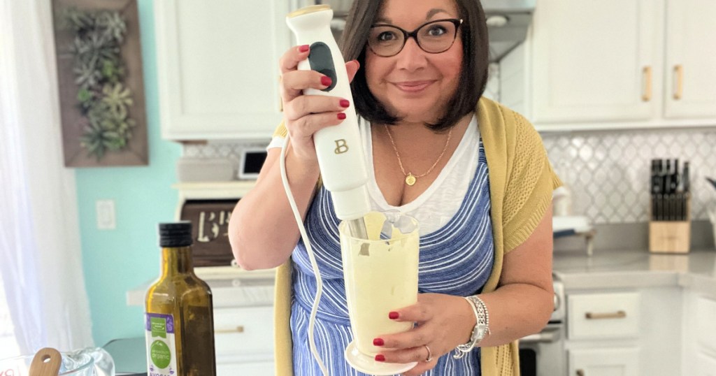 woman using hand blender to make mayo