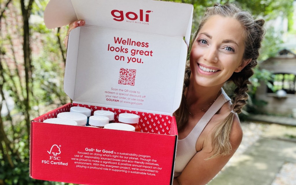 woman with goli supplement package