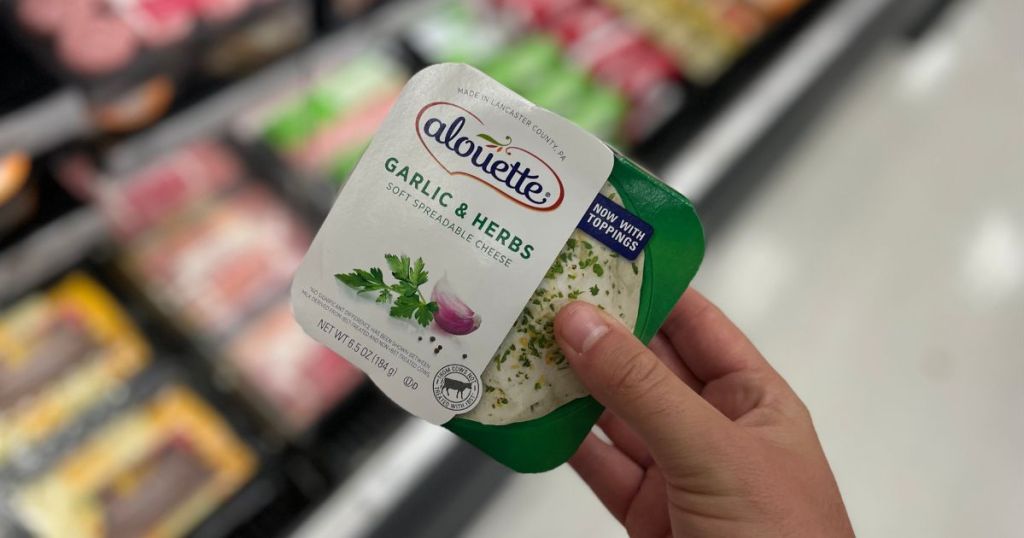 hand holding Alouette spreadable cheese