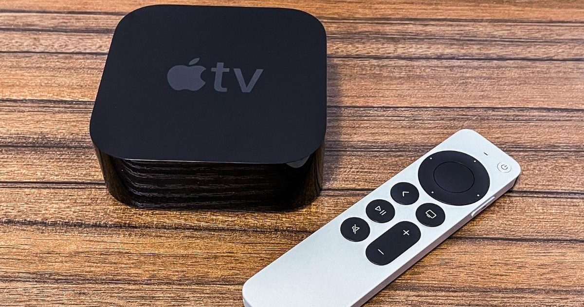 Apple TV HD on a wooden surface next to a remote
