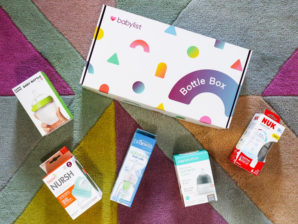 baby bottles in boxes on colorful rug