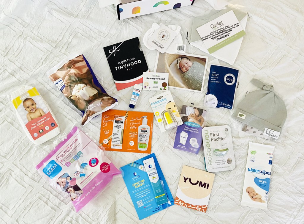 baby product samples laid out on bed