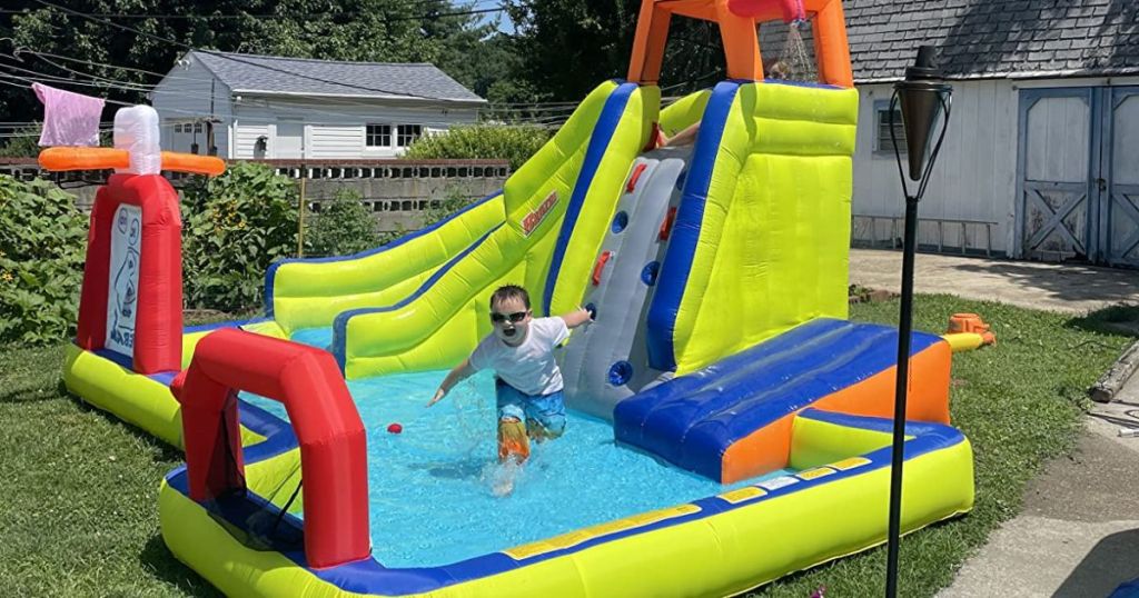 little boy playing in a Banzai Inflatable Water Park