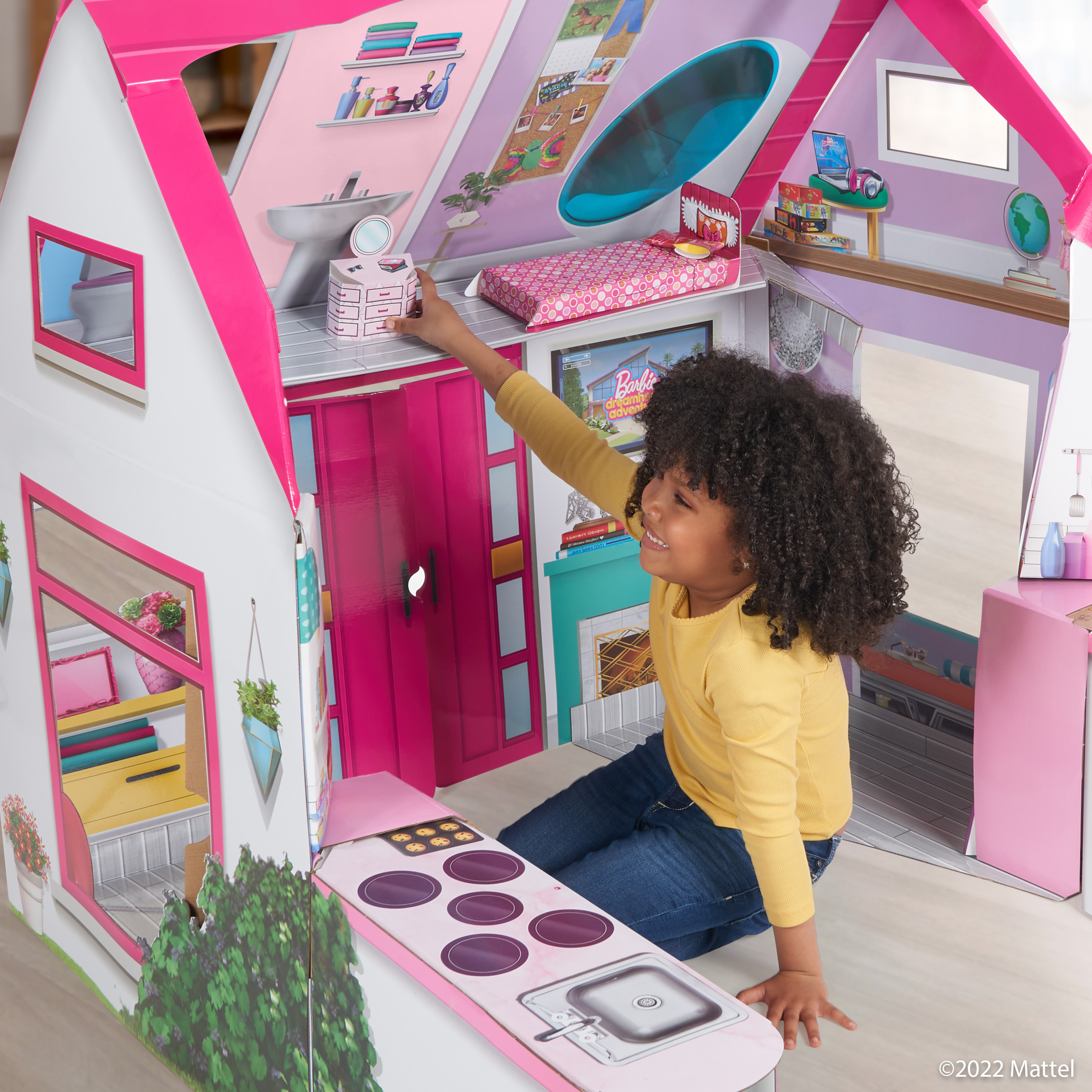 girl playing inside Barbie Playhouse