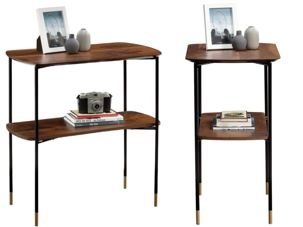 wood and black console tables filled with decor