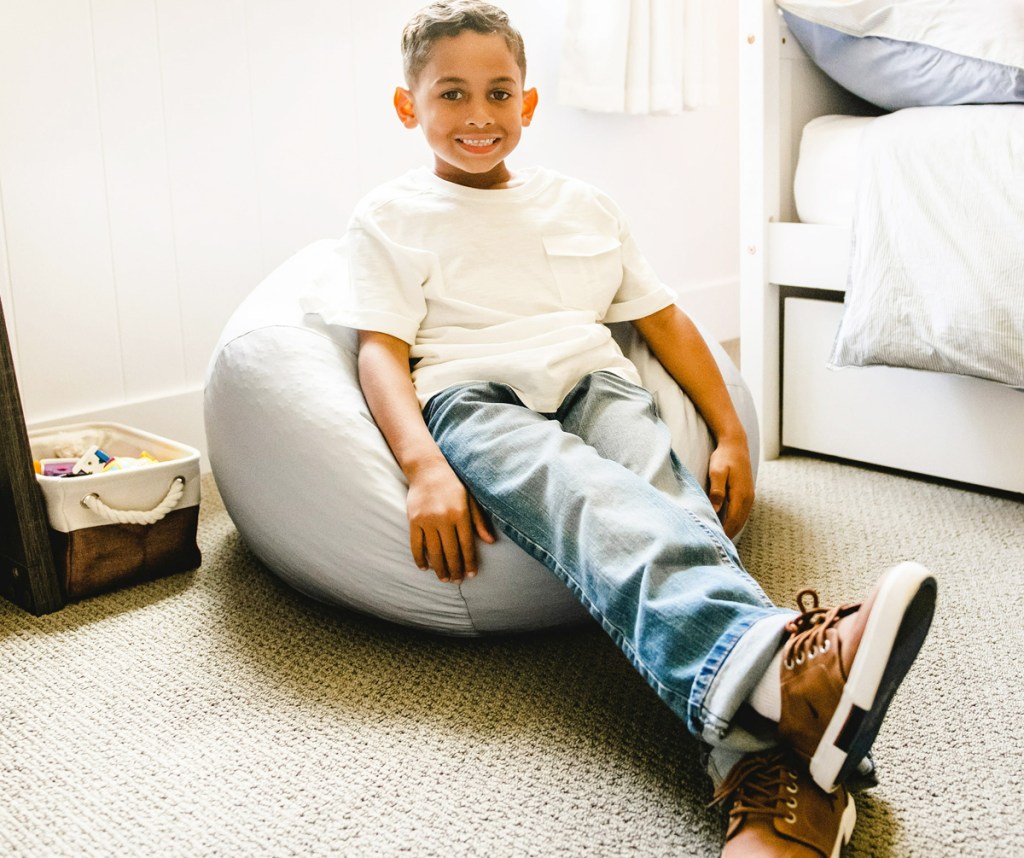 boy sitting in bean bag chair