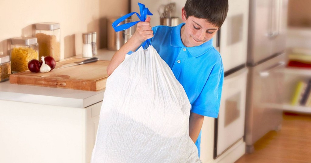 Boy putting away trash