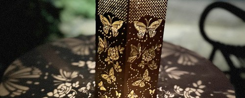 solar lantern casting butterfly pattern on table