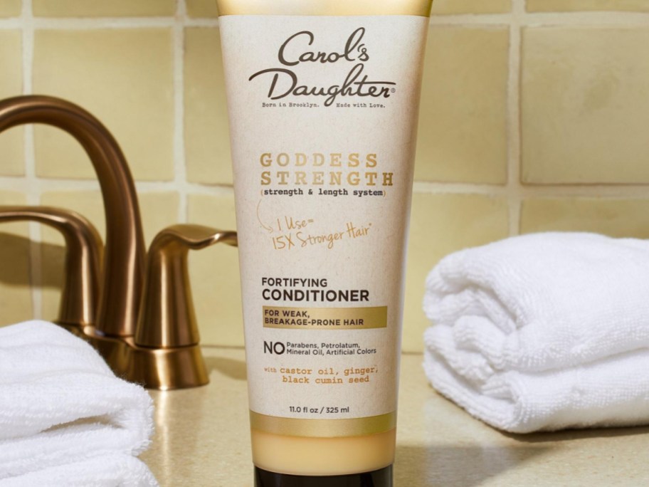 Carols Daughter goddess conditioner with faucet and towel behind it