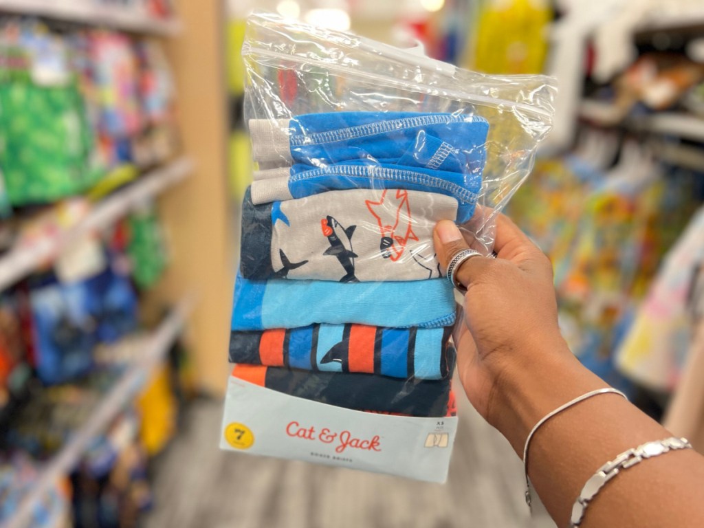 hand holding pack of boys underwear in store