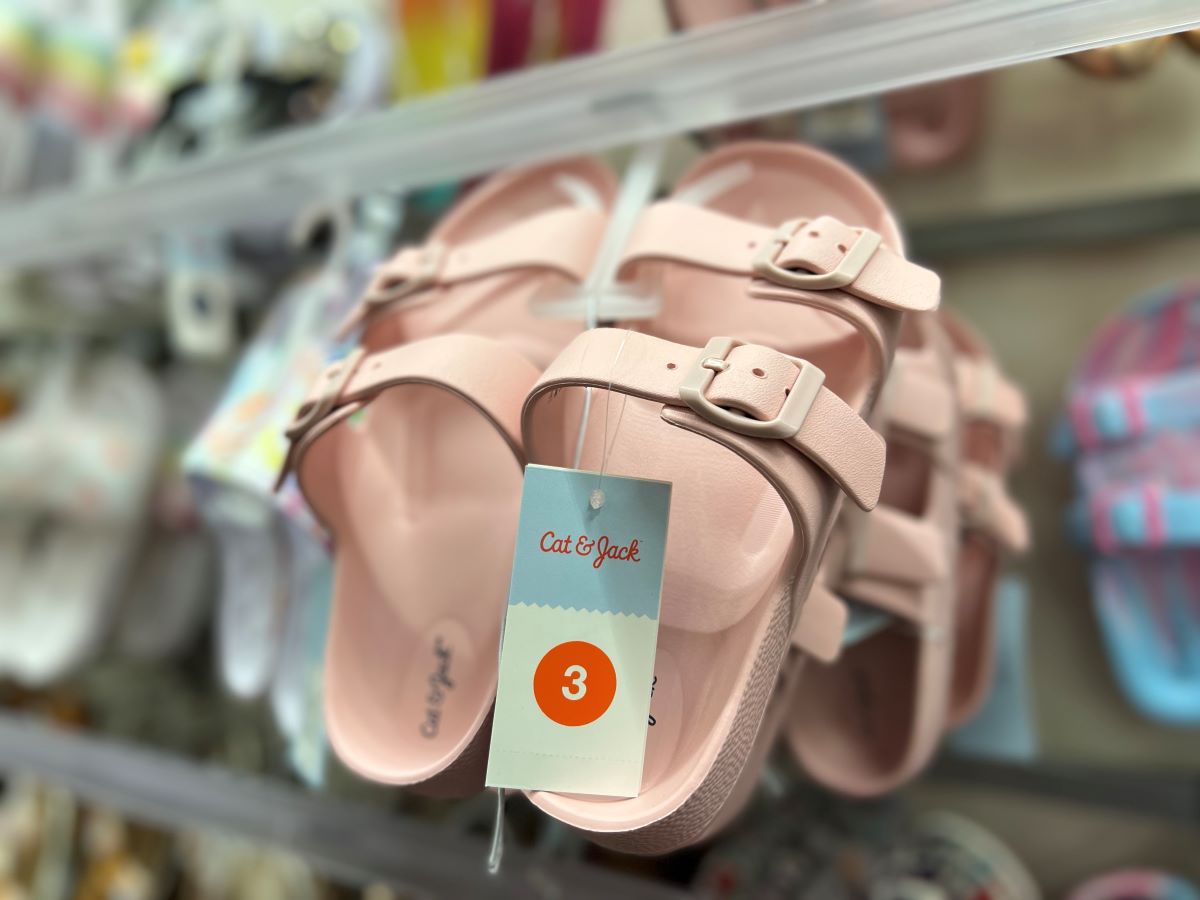 Pair of pink slide sandals on a hanger at Target
