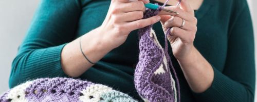 woman knitting an afghan